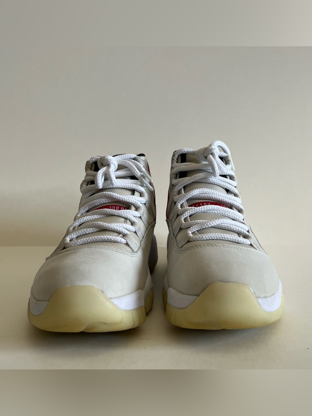 Air Jordan 11 Retro “PLATINUM TINT” Sneakers in White and Cream with Red Accents